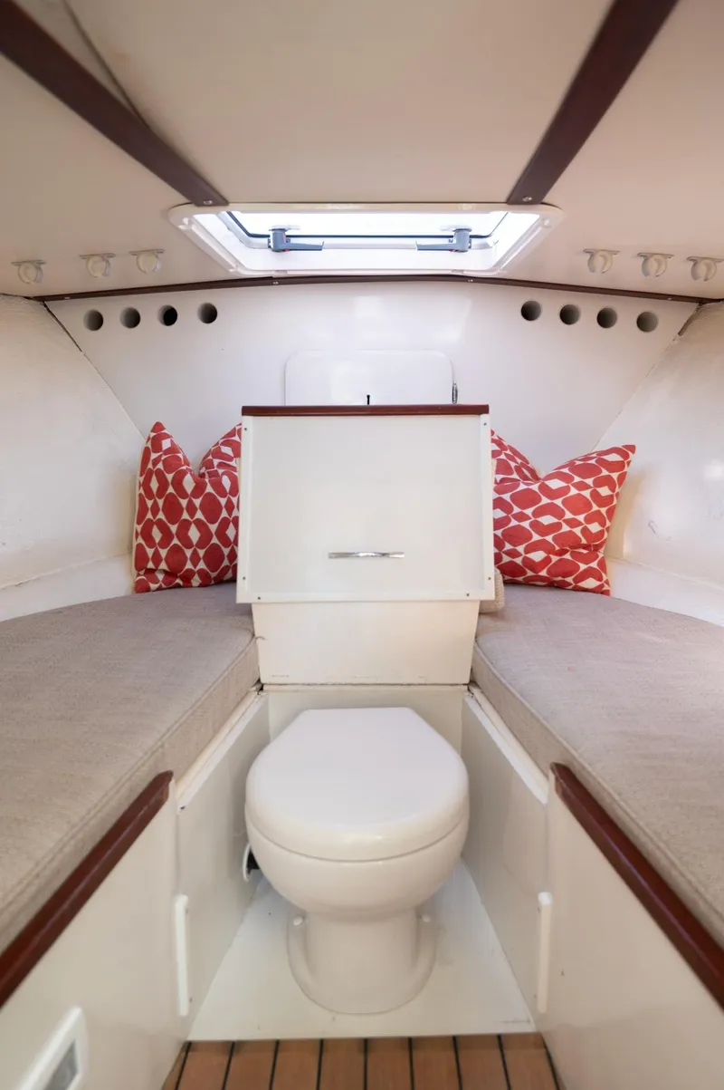 Slide: The Image of 1969 Bertram 31 Classic cabin interior with cozy bedding and decorative pillows. - 9