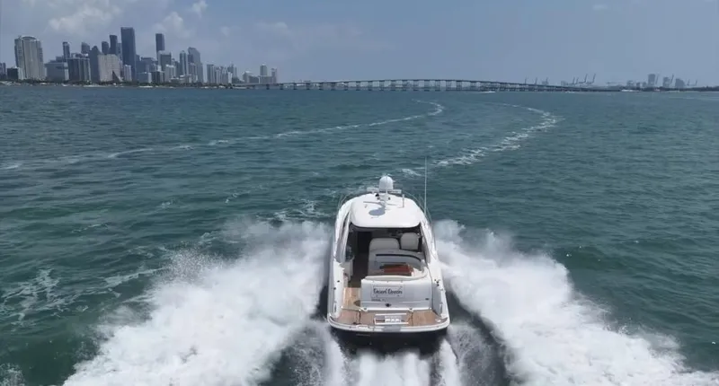 Slide: The Image of 2007 Sea Ray 40 Sundancer cruising near city skyline and bridge. - 11