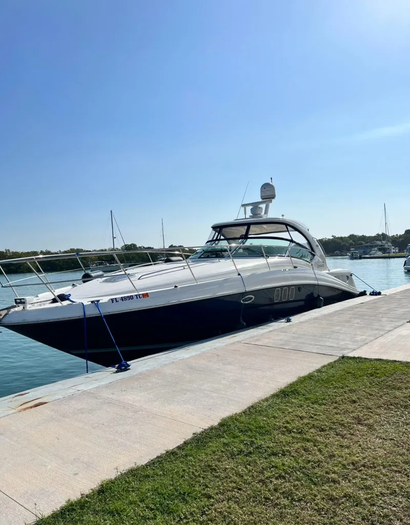 Slide: The Image of 2007 Sea Ray 40 Sundancer yacht docked at marina under clear blue sky. - 13