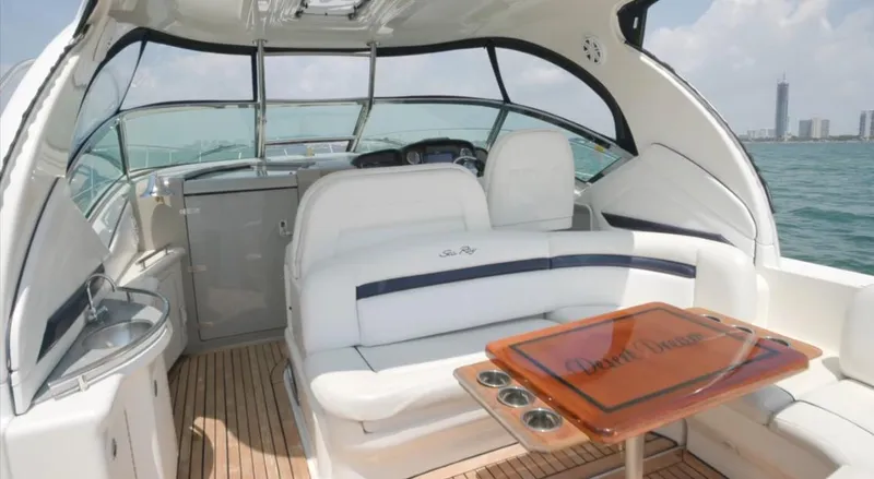 Slide: The Image of 2007 Sea Ray 40 Sundancer yacht interior with white seating and wooden table. - 16