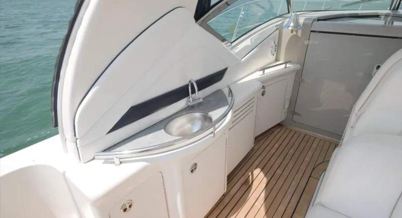 Slide: The Image of 2007 Sea Ray 40 Sundancer yacht interior with sleek kitchenette and wooden flooring. - 17