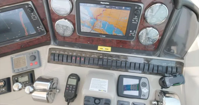 Slide: The Image of Control panel of a 2007 Sea Ray 40 Sundancer with navigation and monitoring systems. - 26