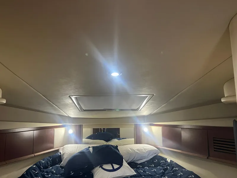 Slide: The Image of Interior cabin of 2007 Sea Ray 40 Sundancer with cozy bedding and ambient lighting. - 32