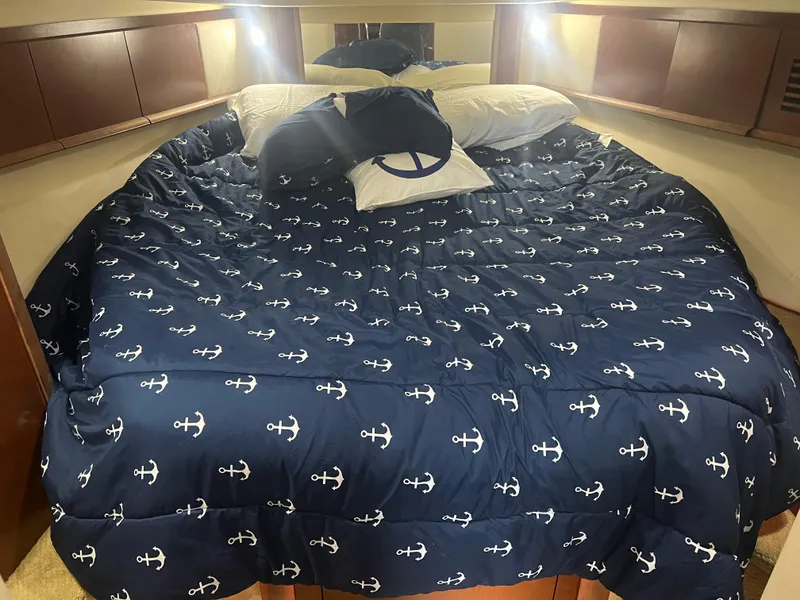 Slide: The Image of Luxurious cabin bed in 2007 Sea Ray 40 Sundancer with nautical-themed bedding. - 35
