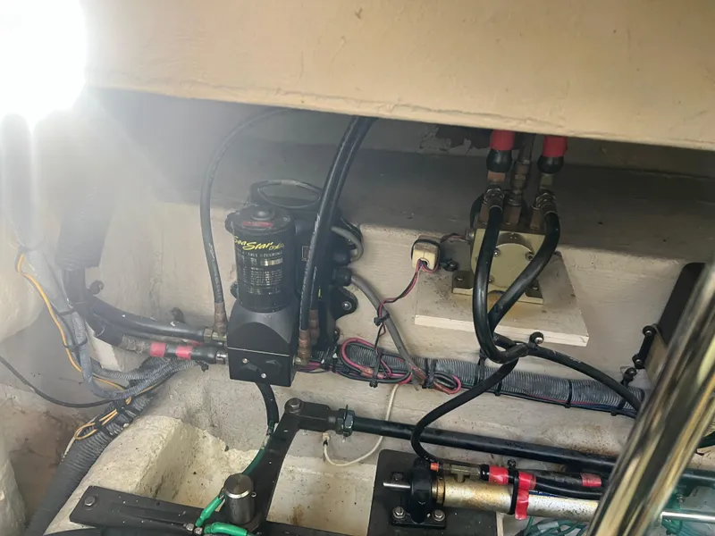 Slide: The Image of Engine compartment of a 2007 Sea Ray 40 Sundancer with visible wiring and hydraulic components. - 38