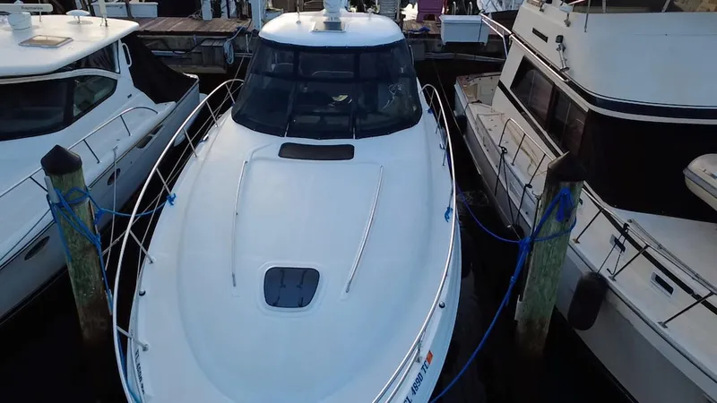 Slide: The Image of 2007 Sea Ray 40 Sundancer yacht docked between two boats. - 44