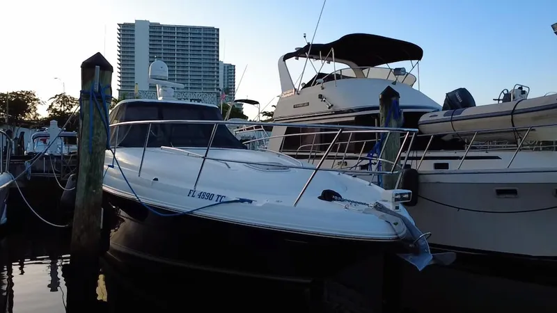 Slide: The Image of 2007 Sea Ray 40 Sundancer yacht docked at marina, with cityscape background. - 45