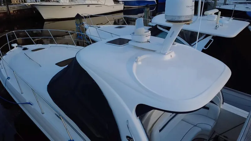 Slide: The Image of 2007 Sea Ray 40 Sundancer yacht docked at marina, featuring sleek white design. - 48