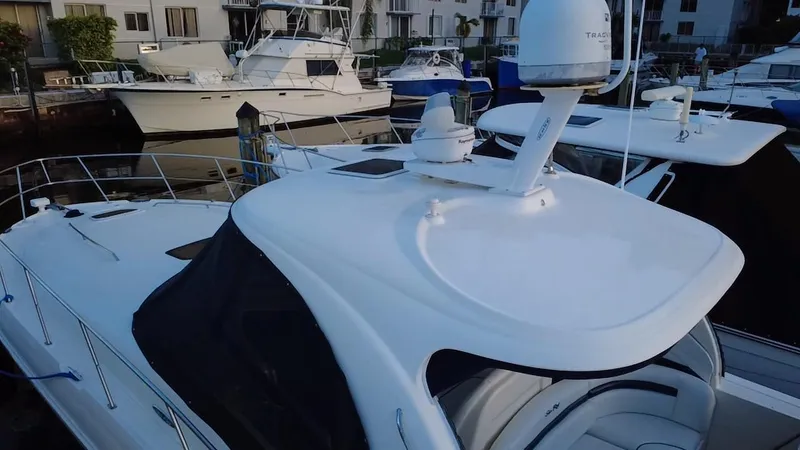 Slide: The Image of 2007 Sea Ray 40 Sundancer yacht docked at marina, featuring sleek design and radar equipment. - 49