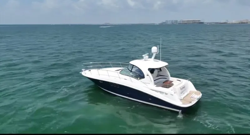 Slide: The Image of 2007 Sea Ray 40 Sundancer yacht cruising on open water under a clear sky. - 5