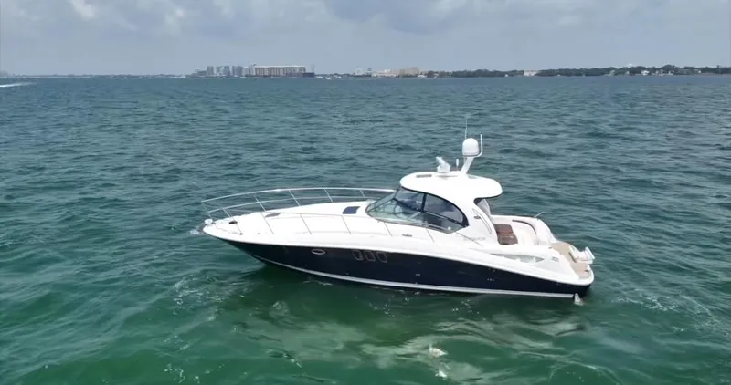 Slide: The Image of 2007 Sea Ray 40 Sundancer yacht cruising on open water under a cloudy sky. - 64