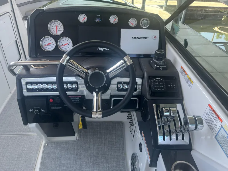 Slide: The Image of 2023 Formula 310 Bowrider I/O dashboard with steering wheel and control panel. - 10