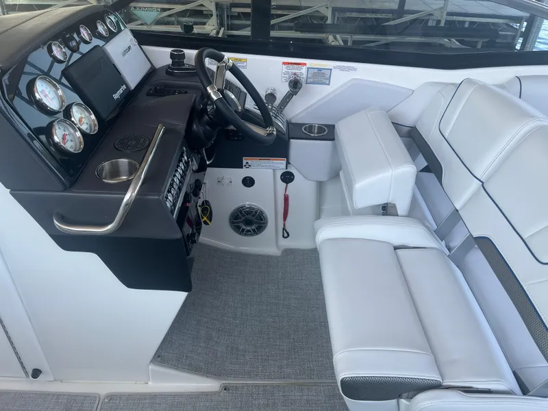 Slide: The Image of 2023 Formula 310 Bowrider I/O cockpit with modern controls and white seating. - 11