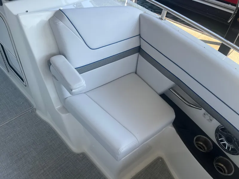 Slide: The Image of 2023 Formula 310 Bowrider I/O interior seating with white upholstery and cup holders. - 15