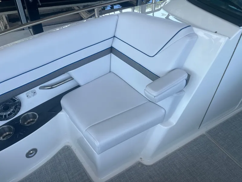 Slide: The Image of 2023 Formula 310 Bowrider I/O interior with white seating and cup holders. - 16