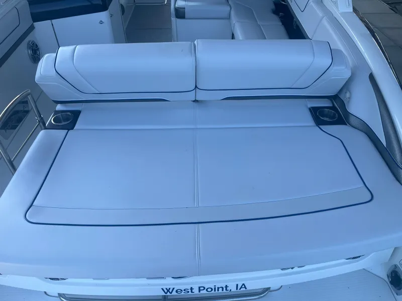 Slide: The Image of 2023 Formula 310 Bowrider I/O boat interior with white seating and cup holders. - 3