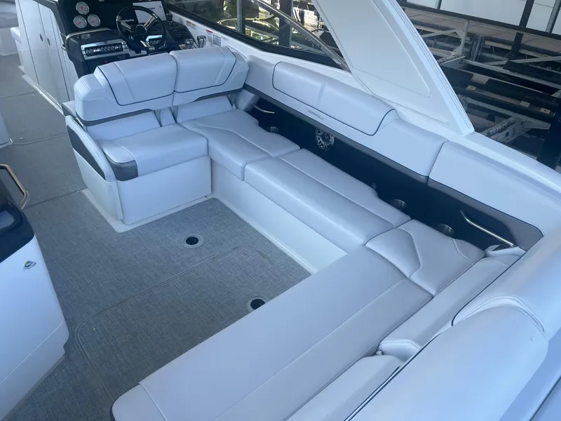 Slide: The Image of 2023 Formula 310 Bowrider I/O interior with luxurious white seating and modern dashboard. - 4