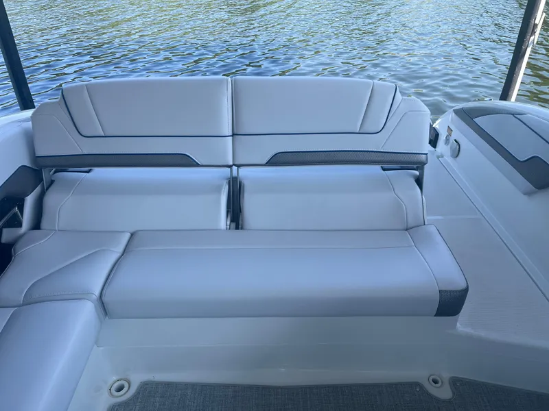 Slide: The Image of 2023 Formula 310 Bowrider I/O boat interior with sleek seating by the water. - 6