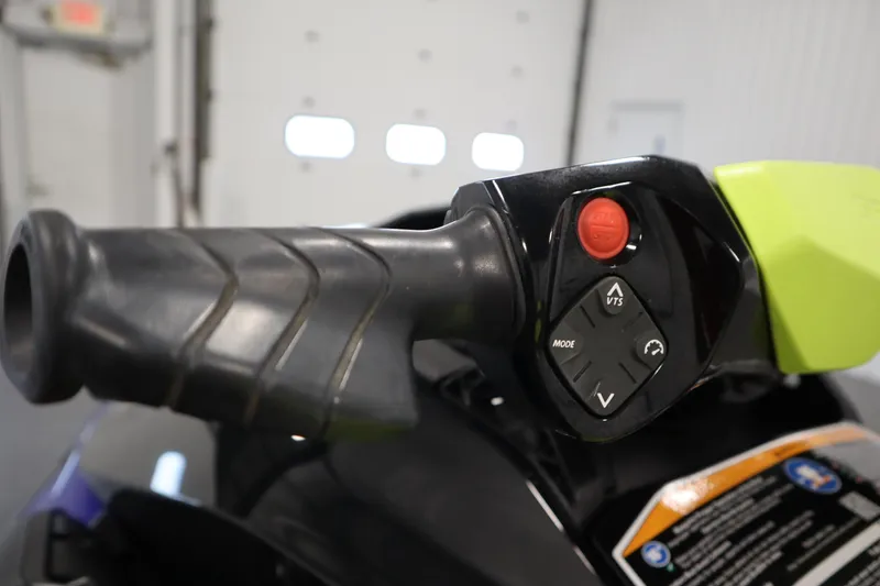 Slide: The Image of Close-up of 2020 Sea-Doo Wake 170 SS handlebar controls in a garage setting. - 12