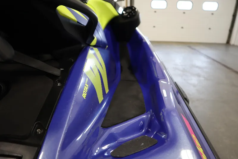 Slide: The Image of 2020 Sea-Doo Wake 170 SS jet ski, blue and yellow design, indoor setting. - 21