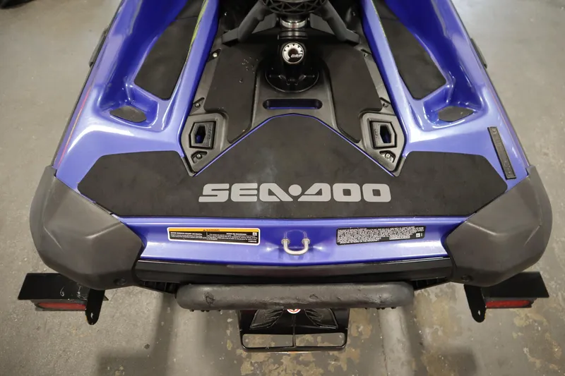 Slide: The Image of 2020 Sea-Doo Wake 170 SS, rear view, blue and black design, in a showroom. - 23