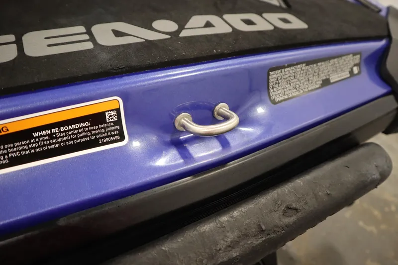 Slide: The Image of 2020 Sea-Doo Wake 170 SS, blue exterior, close-up of re-boarding handle and safety warning label. - 24