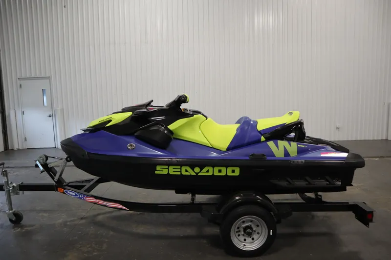 Slide: The Image of 2020 Sea-Doo Wake 170 SS jet ski on trailer, vibrant green and blue design. - 8
