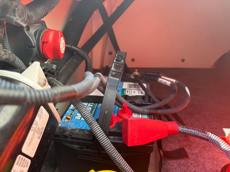 Slide: The Image of 2019 Yamaha Boats AR195 battery compartment with cables and connections. - 17