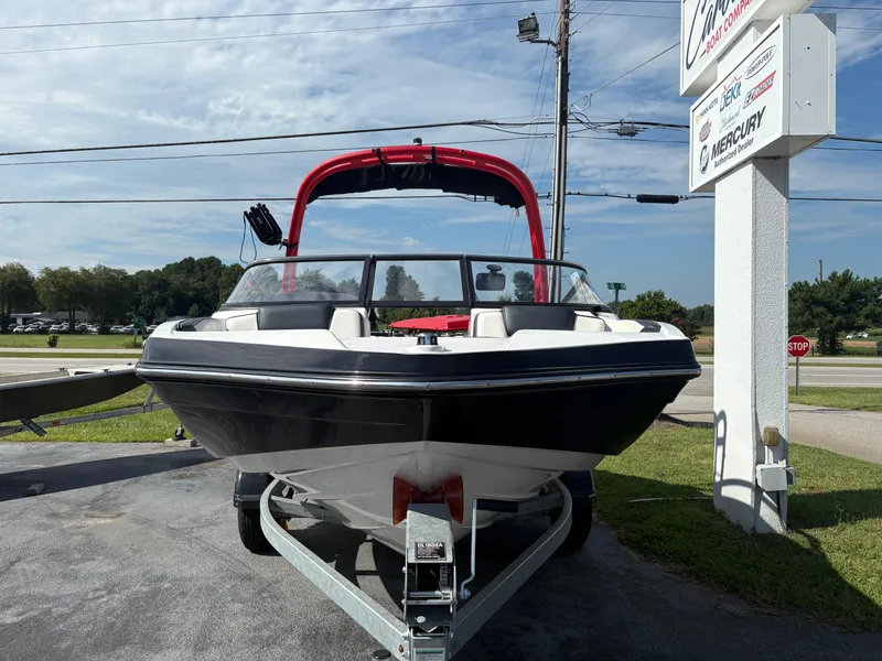Slide: The Image of 2019 Yamaha AR195 boat on trailer, displayed outdoors near dealership sign. - 4