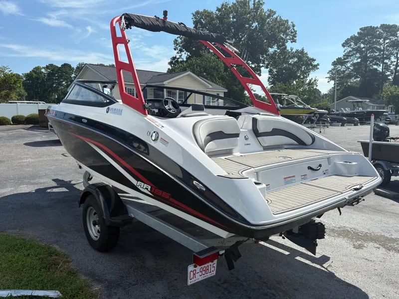 Slide: The Image of 2019 Yamaha AR195 boat with sleek design and red accents, parked on a trailer. - 6