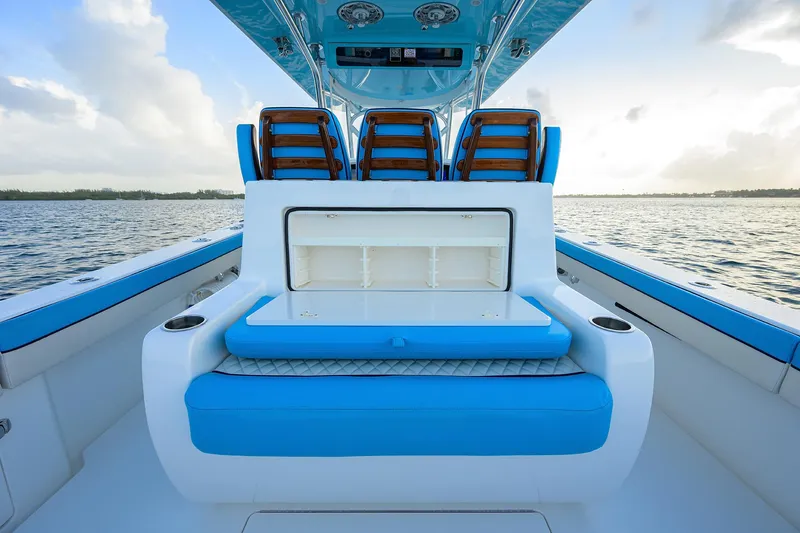 Slide: The Image of 2022 Valhalla Boatworks V-37 interior with blue seating and storage, on calm water. - 19