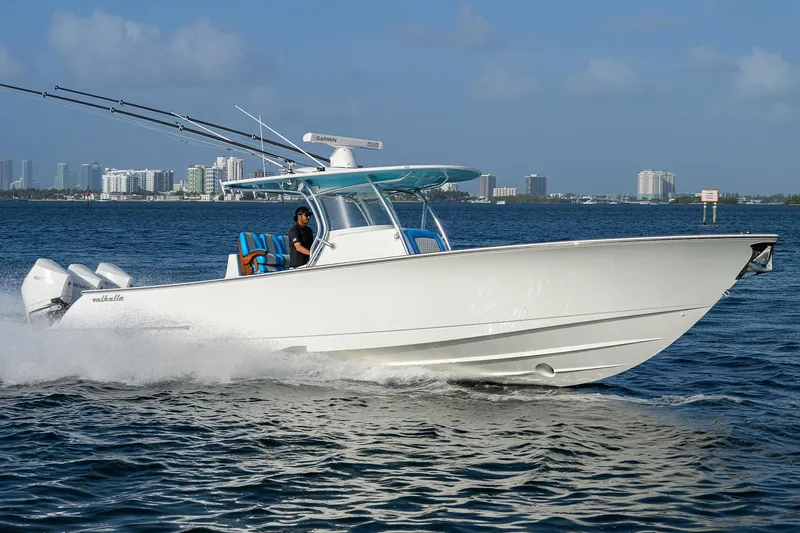 Slide: The Image of 2022 Valhalla Boatworks V-37 cruising on water with city skyline in background. - 2