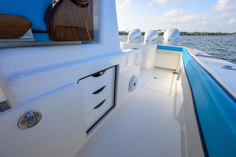 Slide: The Image of 2022 Valhalla Boatworks V-37 interior with storage drawers and triple Mercury engines. - 21