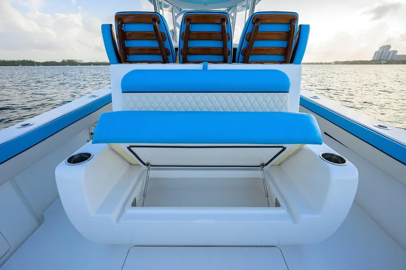 Slide: The Image of 2022 Valhalla V-37 boat with blue seating and storage compartment, on calm water. - 22