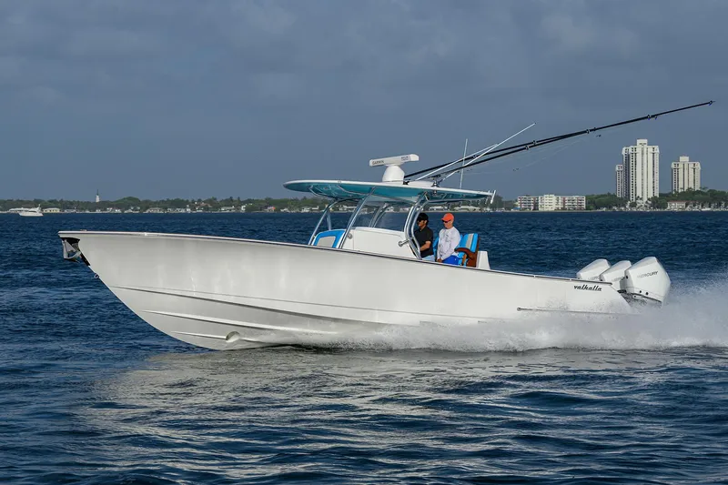 Slide: The Image of 2022 Valhalla Boatworks V-37 cruising on open water with cityscape in background. - 4