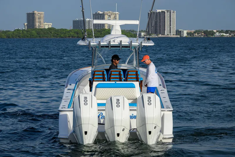 Slide: The Image of 2022 Valhalla Boatworks V-37 on water with two people, cityscape in background. - 5