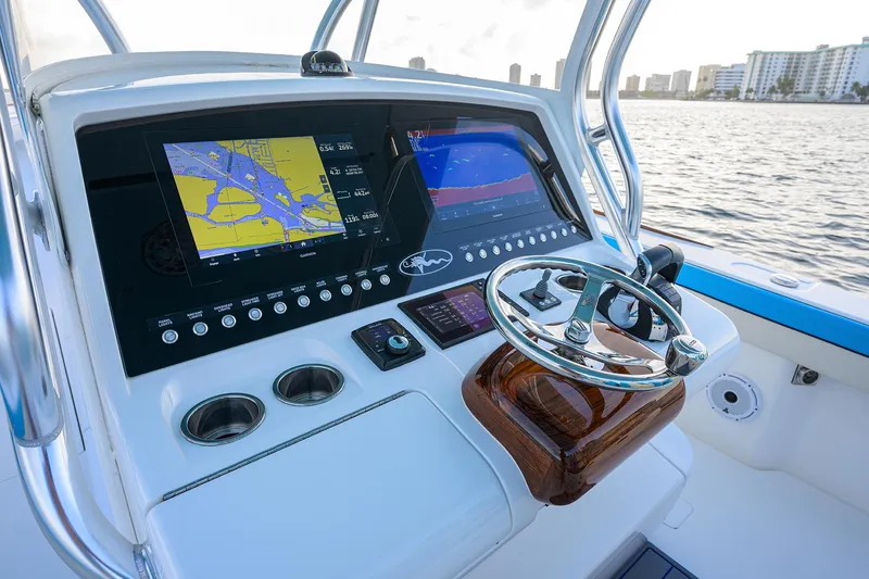 Slide: The Image of 2022 Valhalla Boatworks V-37 helm with navigation screens and steering wheel. - 7