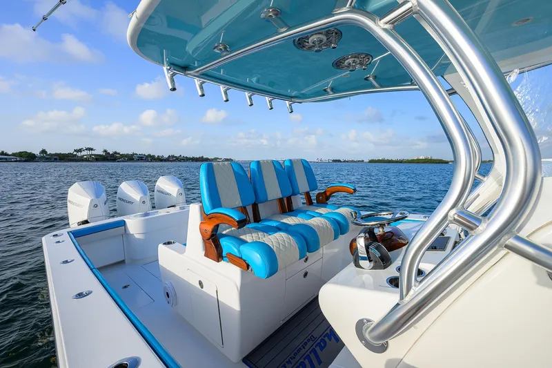 Slide: The Image of 2022 Valhalla Boatworks V-37 with blue seating and multiple outboard engines on the water. - 9