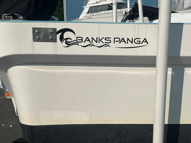 Slide: The Image of 2023 Banks Panga 26 Panga boat with logo on the side. - 6