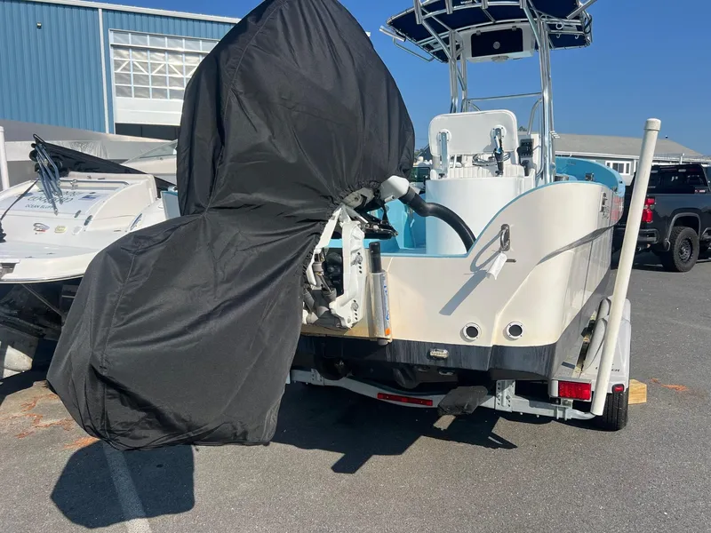 Slide: The Image of 2023 Banks Panga 26 Panga boat on trailer, covered engine, outdoor setting. - 7