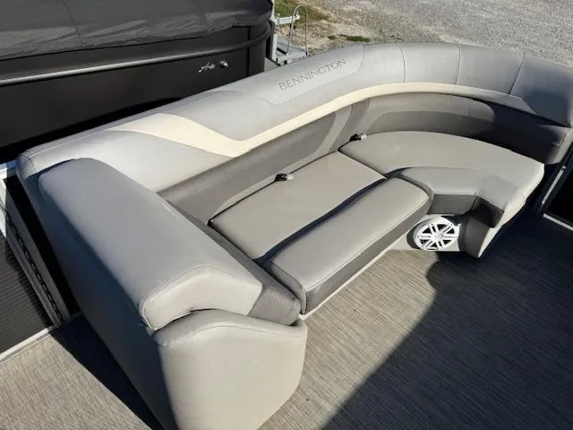 Slide: The Image of 2020 Bennington SX22 boat interior with gray cushioned seating and speaker. - 12