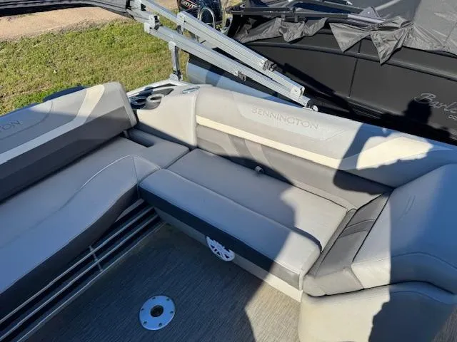 Slide: The Image of 2020 Bennington SX22 boat interior with gray seating and cup holders. - 14