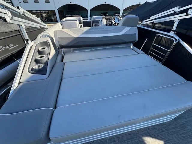 Slide: The Image of 2020 Bennington SX22 boat interior with gray seating and cup holders. - 19