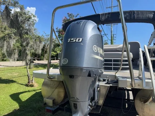 Slide: The Image of 2020 Bennington SX22 boat with Yamaha 150 engine, parked outdoors on a sunny day. - 20