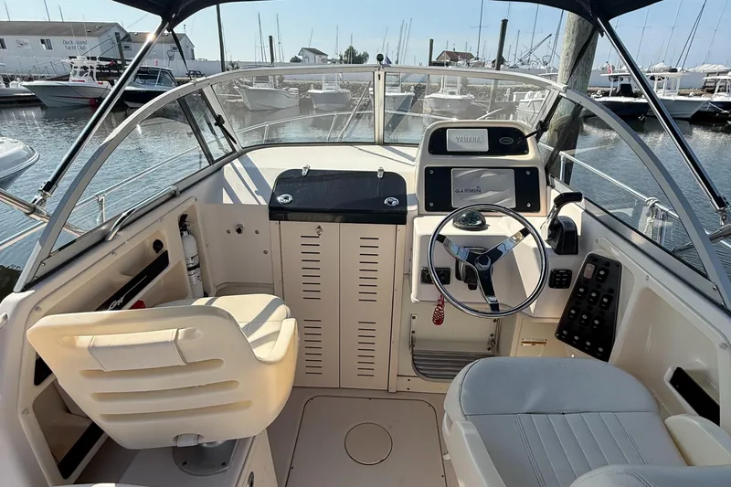 Slide: The Image of 2011 Grady-White 226 Seafarer WA boat cockpit with steering wheel and navigation equipment. - 5