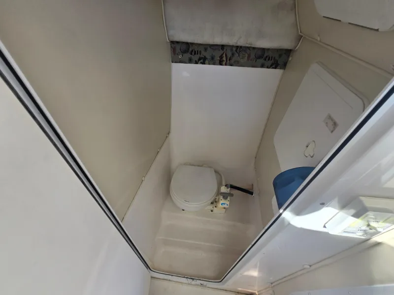 Slide: The Image of 2008 Baha Cruisers 277 GLE OB boat deck view with windshield and docked boats. - 15