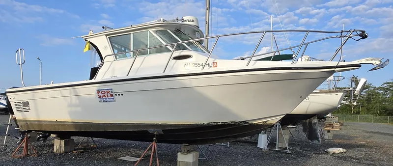 Slide: The Image of 2008 Baha Cruisers 277 GLE OB boat for sale, displayed on stands outdoors. - 3