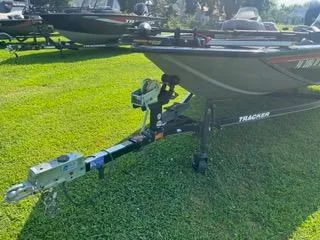 Slide: The Image of 2016 Tracker Pro Team 195 TXW boat on grassy field, trailer attached. - 12