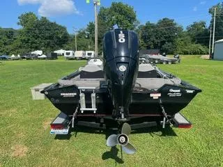 Slide: The Image of 2016 Tracker Pro Team 195 TXW boat on grass, rear view with motor. - 4