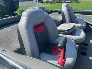Slide: The Image of 2016 Tracker Pro Team 195 TXW boat seats, gray with red accents, outdoor setting. - 5